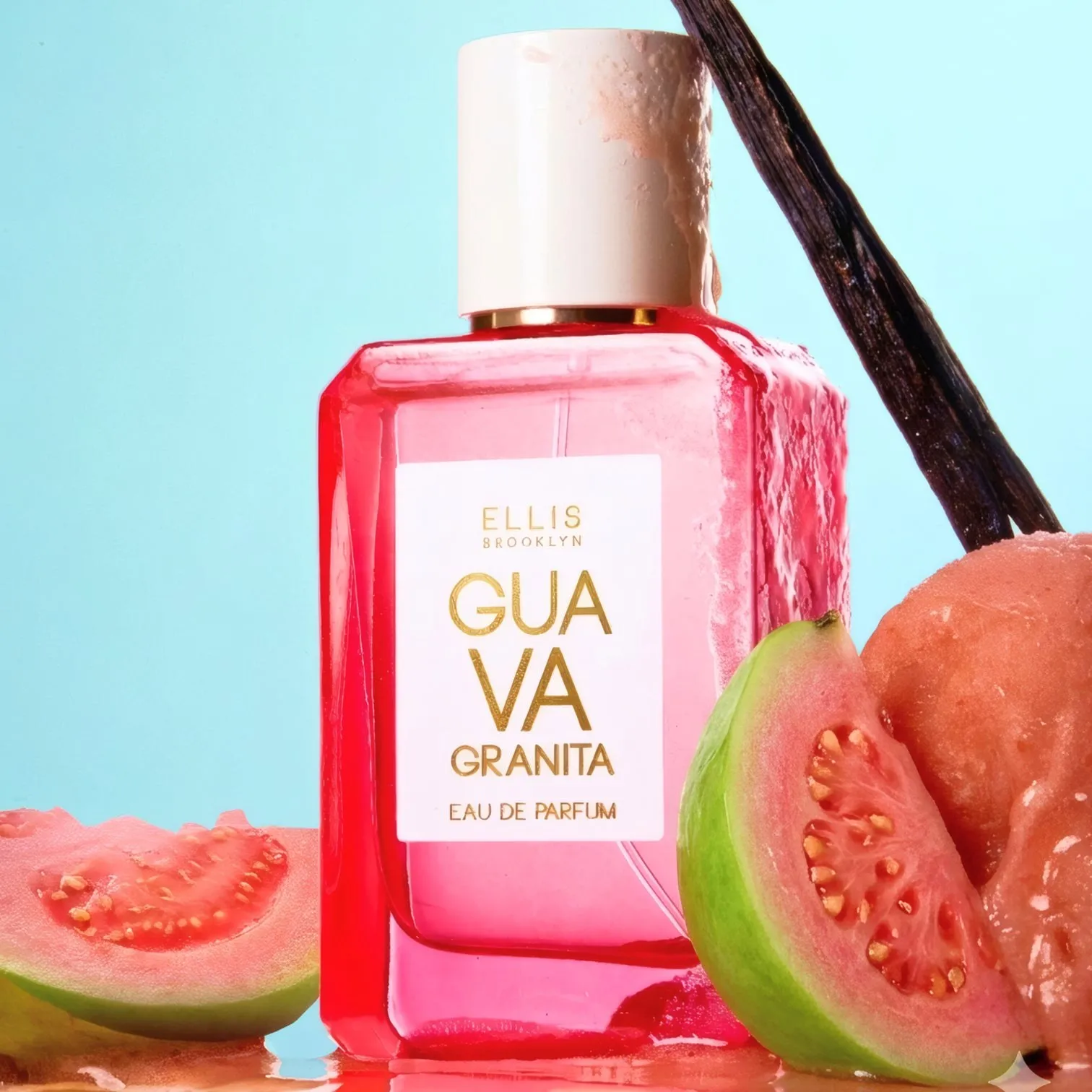A bottle of Ellis Brooklyn Guava Granita eau de parfum beside fresh guava halves