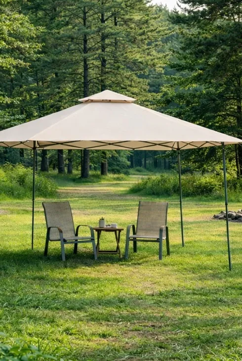 A Garden Winds canopy shading patio chairs in a leafy backyard